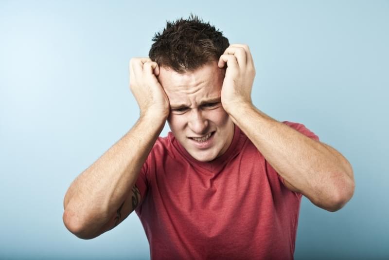 Confused man holding his head, How Do I Take the First Step in Martial Arts and Self Defense Training, Edmonton
