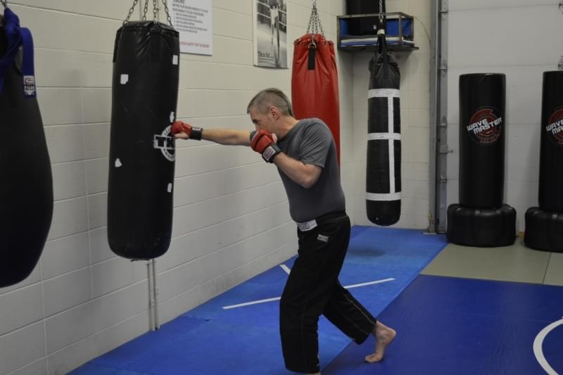 Coach Calen Paine hits the bags, boxing, kickboxing, the Most Important Thing to Consider When Starting Any Fitness Program, Edmonton.